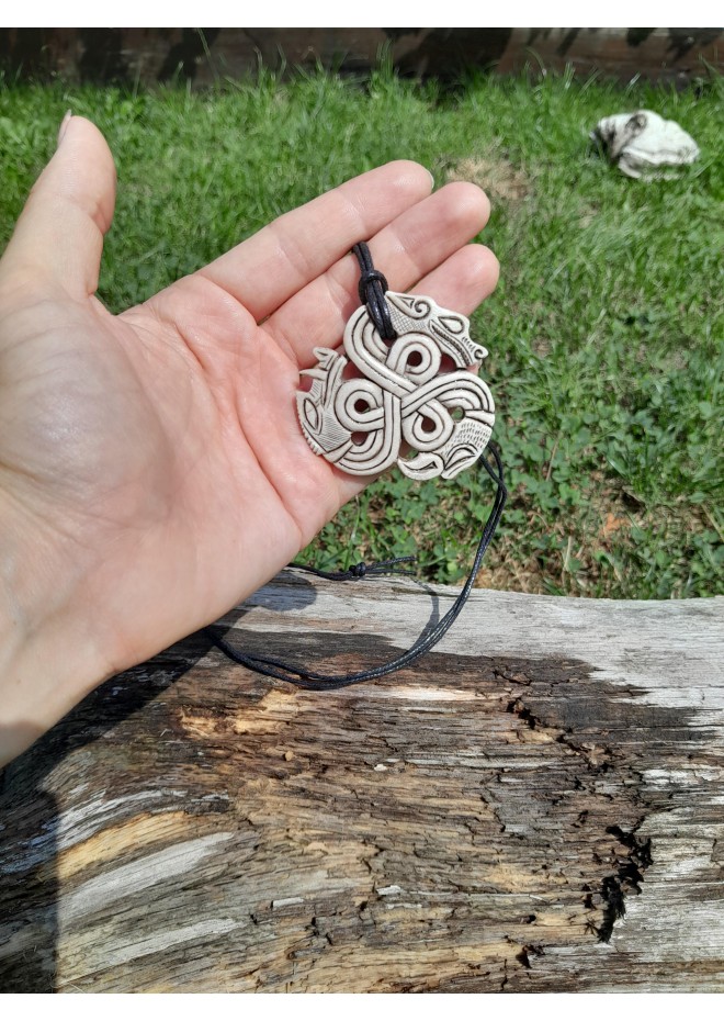 A triskelion amulet with heads of a Boar, Raven and Wolf. Norse, pagan jewelry. Norse mythology art. Altarpiece.