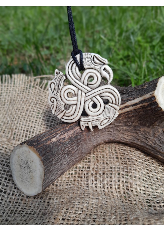 A triskelion amulet with heads of a Boar, Raven and Wolf. Norse, pagan jewelry. Norse mythology art. Altarpiece.