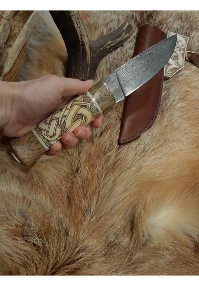 Handmade designer knife in the Norse style. Hand-carved handle with hand-forged Damascus blade, leather sheath. Viking zoomorphic knotwork