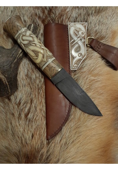 Handmade designer knife in the Norse style. Hand-carved handle with hand-forged Damascus blade, leather sheath. Viking zoomorphic knotwork