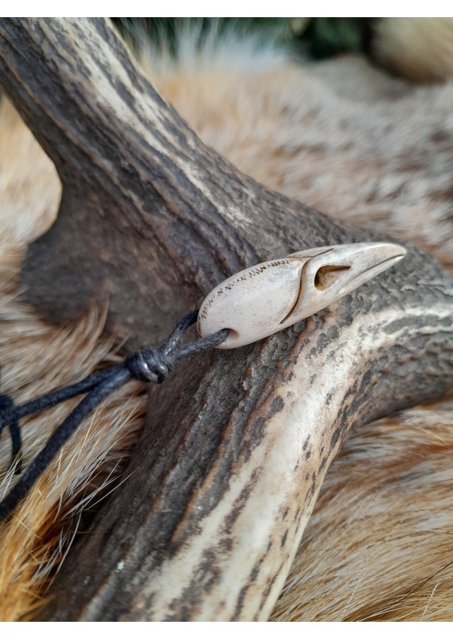 Small hand-carved Viking Raven skull amulet inspired by Norse mythology.