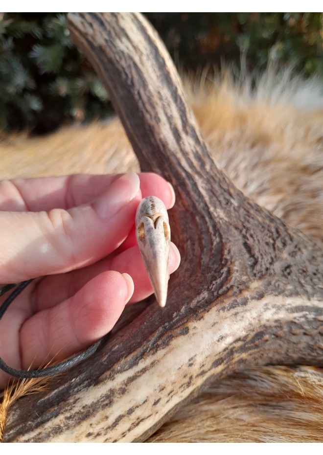 Small hand-carved Viking Raven skull amulet inspired by Norse mythology.