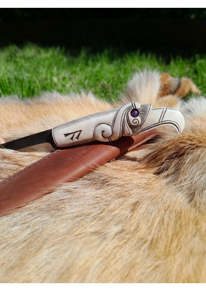 Viking knife with hand-carved Raven handle. Hand-forged carbon steel blade and leather sheath. 