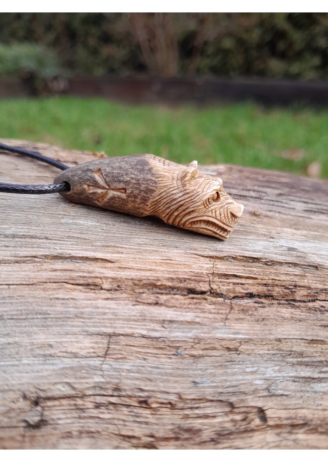 Small hand-carved Viking bear amulet with Algiz and Dagaz runes. Norse jewelry